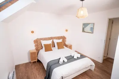 Un ou plusieurs lits dans un hébergement de l'établissement L'Air du Sud - appartement chaleureux Le Tréport