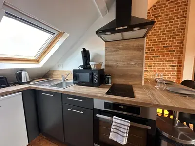 Cuisine ou kitchenette dans l'établissement IMMEUBLE ST-PIERRE - GARE 10min - HORTILLONNAGES 5min - WIFI - TV HD