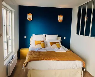 Un ou plusieurs lits dans un hébergement de l'établissement Maison Gabriel Appartement BULLE