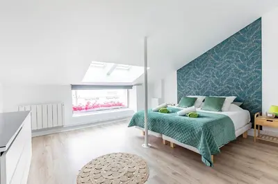 Un ou plusieurs lits dans un hébergement de l'établissement Loft & Spa LE FAUBOURG SAINT MARTIN